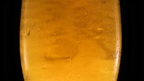 Lager beer with bubbles on black background. Stock Footage 156704429