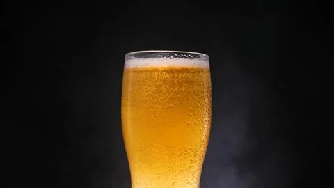 Lager beer with ice effect. Refreshing and cold beer in a beer glass with water Stock Footage 156171133
