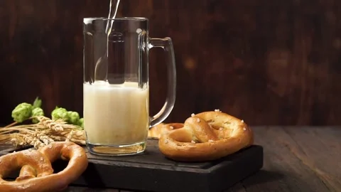 Lager beer is pouring into a mug. Light beer on a wooden table. Stock Footage 115564648