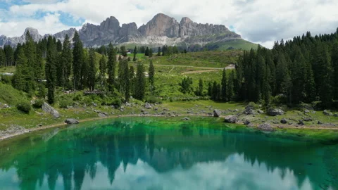 Lago di Carezza reflecting Latemar mountain range in summer Stock Footage 314943871