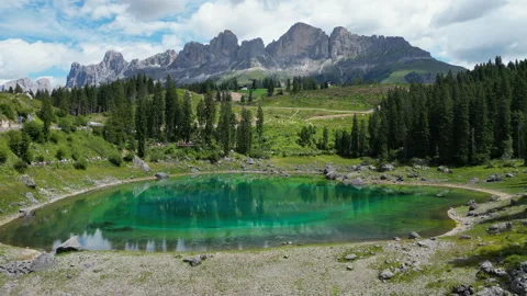 Lago di Carezza reflecting Latemar mountain range in summer Stock Footage 314943941