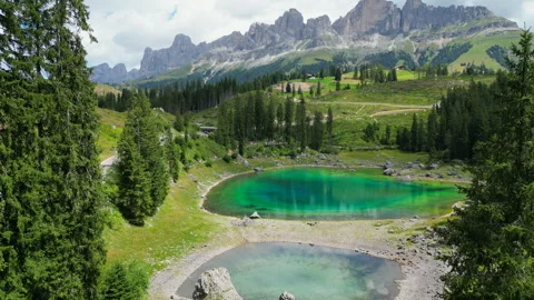 Lago di Carezza reflecting Latemar mountain range in the Dolomites Stock Footage 314944108