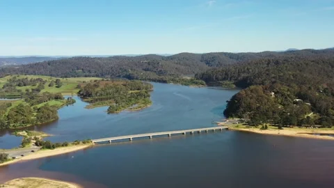 Lagoon of Bega river on Tathra beach, aerial backward flying from briddge 4k. Stock Footage 194481209