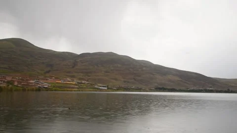 Lagoon with distant mountains and cloudy sky Stock Footage 241452893