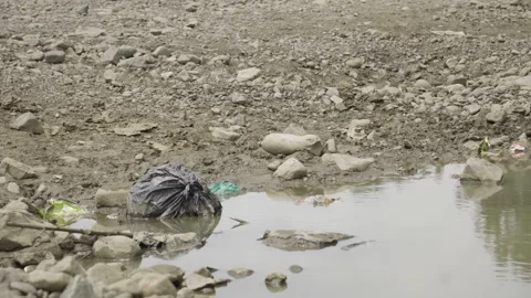 Lagoon drying up due to pollution from garbage bags, global warm, pollution Stock-Footage 272465626