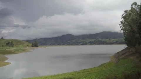 Lagoon surrounded by fog on a cloudy day, surrounding Andean mountains Video stock 277468802