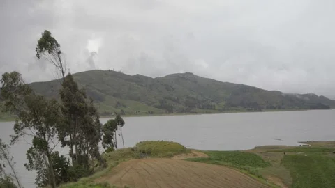 A lagoon surrounded by mountain in the valley of Stock Footage 277468829