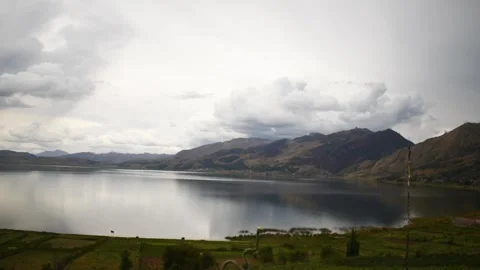 Lagoon view with distant mountains and cloudy sky Stock Footage 241452897