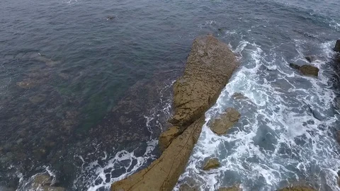 Laguna Beach Cloudy Day - Low Fly Pan Up Passing Surf Paddler Stock-Footage 93679939