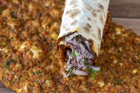 Lahmacun or Turkish pizza with minced meat on a wood background. Turkish food Stock Photos