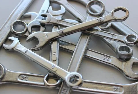 Laid out in disarray on top of each other chrome plated wrenches Stock Photos