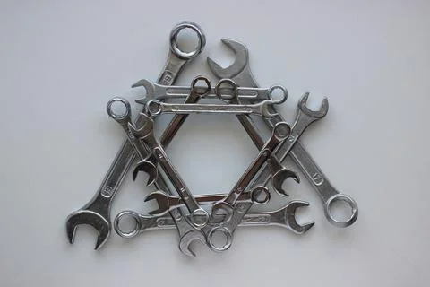 Laid out in a triangular shape, chrome plated wrenches Stock Photos