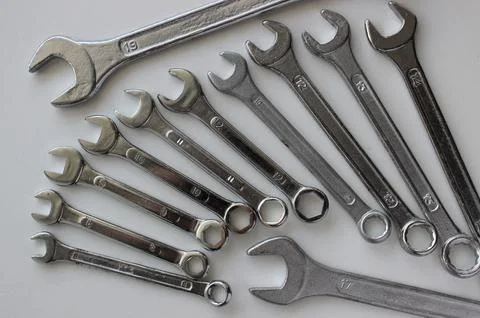 Laid out in a wing shape chrome plated wrenches of different sizes Stock Photos