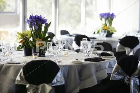 Laid Tables With Floral Decorations In Restaurant