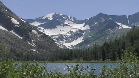 Lake among snow-covered mountain peaks Video stock 108271069