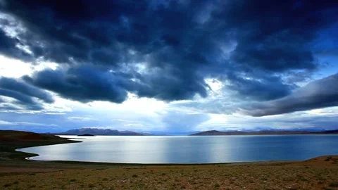Lake and mountains under a cloudy sky landscape Stock Footage 311819681