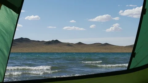 The lake and waves roll into the beach. View from the tourist tent. Stock Footage 79776441
