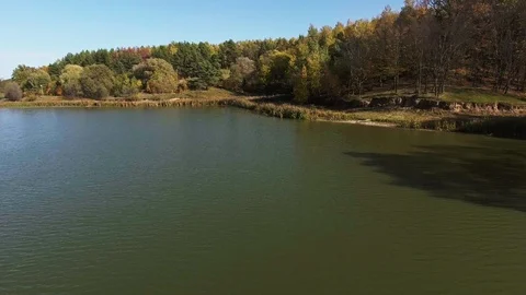 Lake background over blue sky, autumn forest Stock Footage 87837725