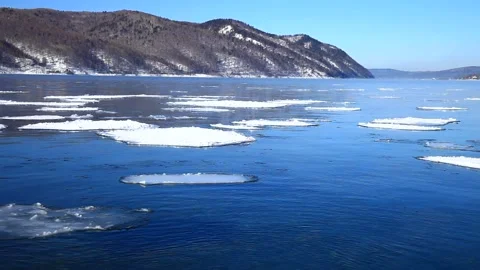 Lake Baikal. Source of Angara River. White ice floats on the blue water Stock Footage 87542770