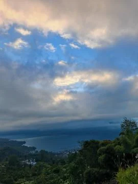 Lake Batur with Dramatic Clouds and Mountain Valley Landscape in Bali Stockfoto's