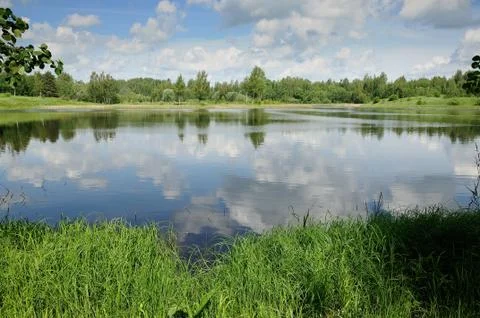 Lake with beautiful reflection of the cloudy sky Stock Photos