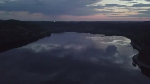 Lake between forests against the backdrop of the setting sun. Stock Footage 149108282