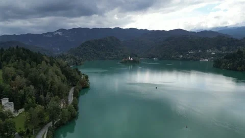 Lake bled island church reflection with castle on mountain cliff Stock Footage 300977341