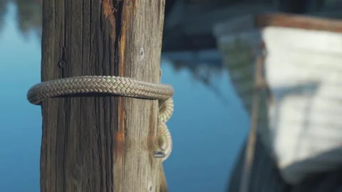 Lake boat tied to post on dock Stock Footage 294521079