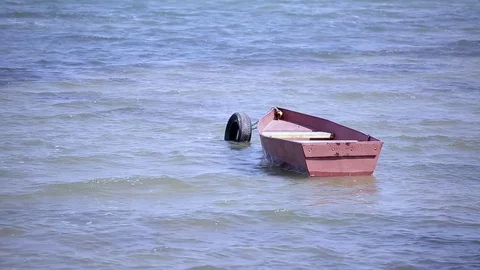 Lake with a boat on waves Stock Footage 74311136
