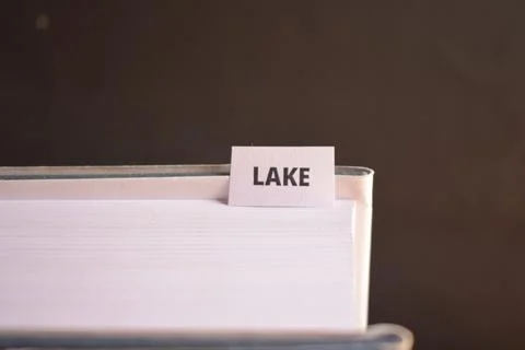 Lake Bookmark Inserted in Book Representing Nature, Freshwater and Scenic L.. Фото
