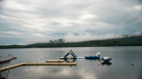 Lake cloud time lapse looking over kids camp lake toys (4k) Stock Footage 132784056