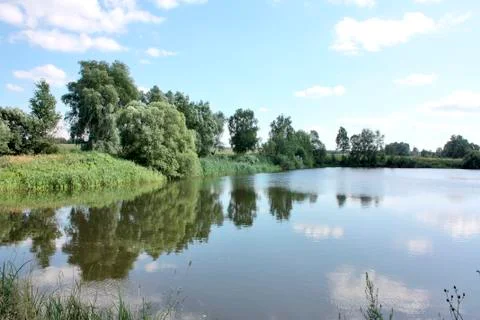 Lake with clouds, clouds reflected in the water of the lake Stock Photos