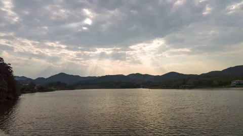 Lake Clouds With Tyndall Rays Casting Patterns Across Water Timelapse Video stock 320396487