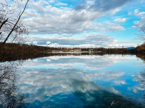 A lake with a cloudy sky in the background Stock-Fotos