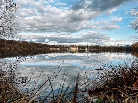 Lake with a cloudy sky in the background Stock Photos
