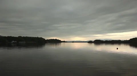 Lake with cloudy sky, calm water reflections and ripples Stock Footage 45125089