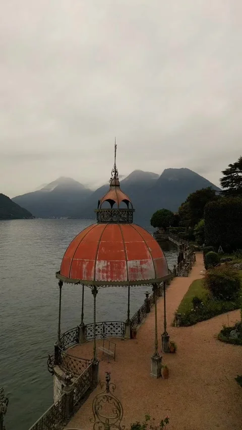 Lake Como in cloudy day flying near historical old chapel Mountain 스톡 동영상 297868990