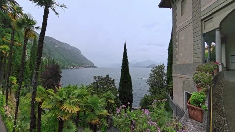 Lake Como Garden with Palm Trees and Mountain View, Italy Vídeos de archivo 344796932