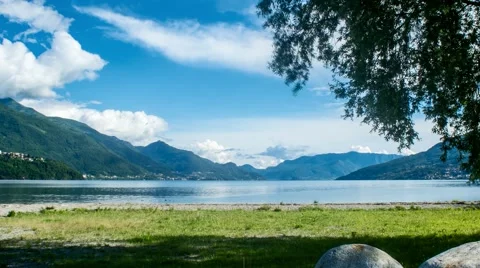 Lake Como with grass, moving clouds and tree Timelapse Video stock 64183133