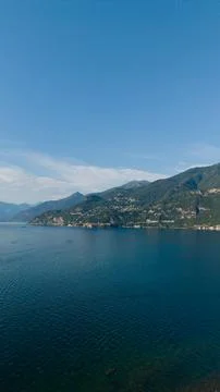 Lake como is presenting its deep blue waters reflecting a clear sky. With the ch Stock Photos
