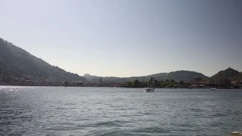 Lake Como summer view calm water boat swan peaceful cityscape Italian Alps tranq Stock Footage 310053357