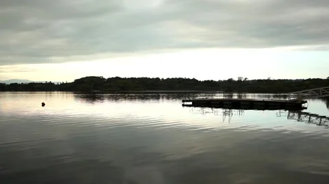 Lake dock at dawn, cloudy sky, beautiful water ripples 스톡 동영상 45125150