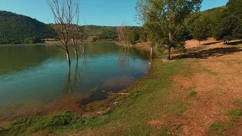 A lake during autumn. Some trees emerge from the water, Autumn season. Aerial Stock Footage 72178058