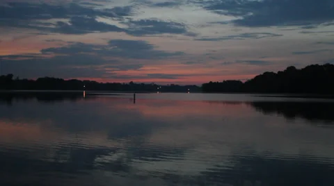 Lake early sunrise in fall with sun reflecting in water Stock Footage 30236459