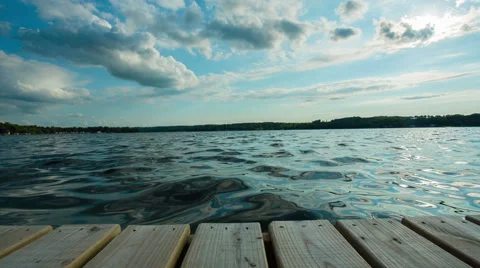 Lake End of Dock Dolly Sun Behind Clouds Video stock 57753250