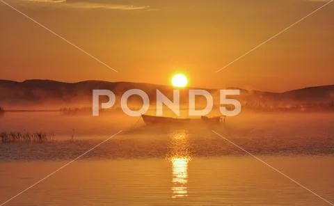 Lake evaporation and fishing boat Stock Photos