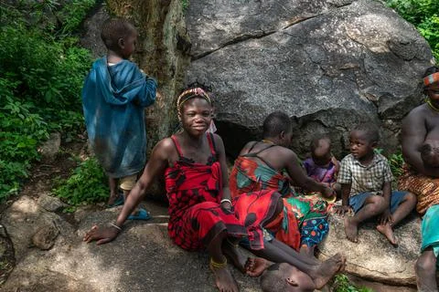 LAKE EYASI, TANZANIA - January 29, 2020: Hadzabe children are resting on a rock. Stock Photos