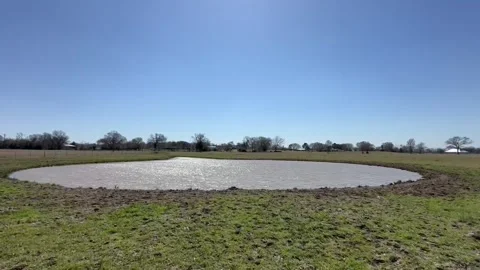 LAKE IN A FARM LANDSCAPE Stock Footage 303510548