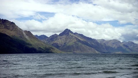 Lake in foreground with alpine mountains behind in South Island NZ Stock Footage 159754900