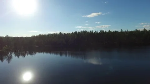 Lake, forest and sun Stock Footage 76719554